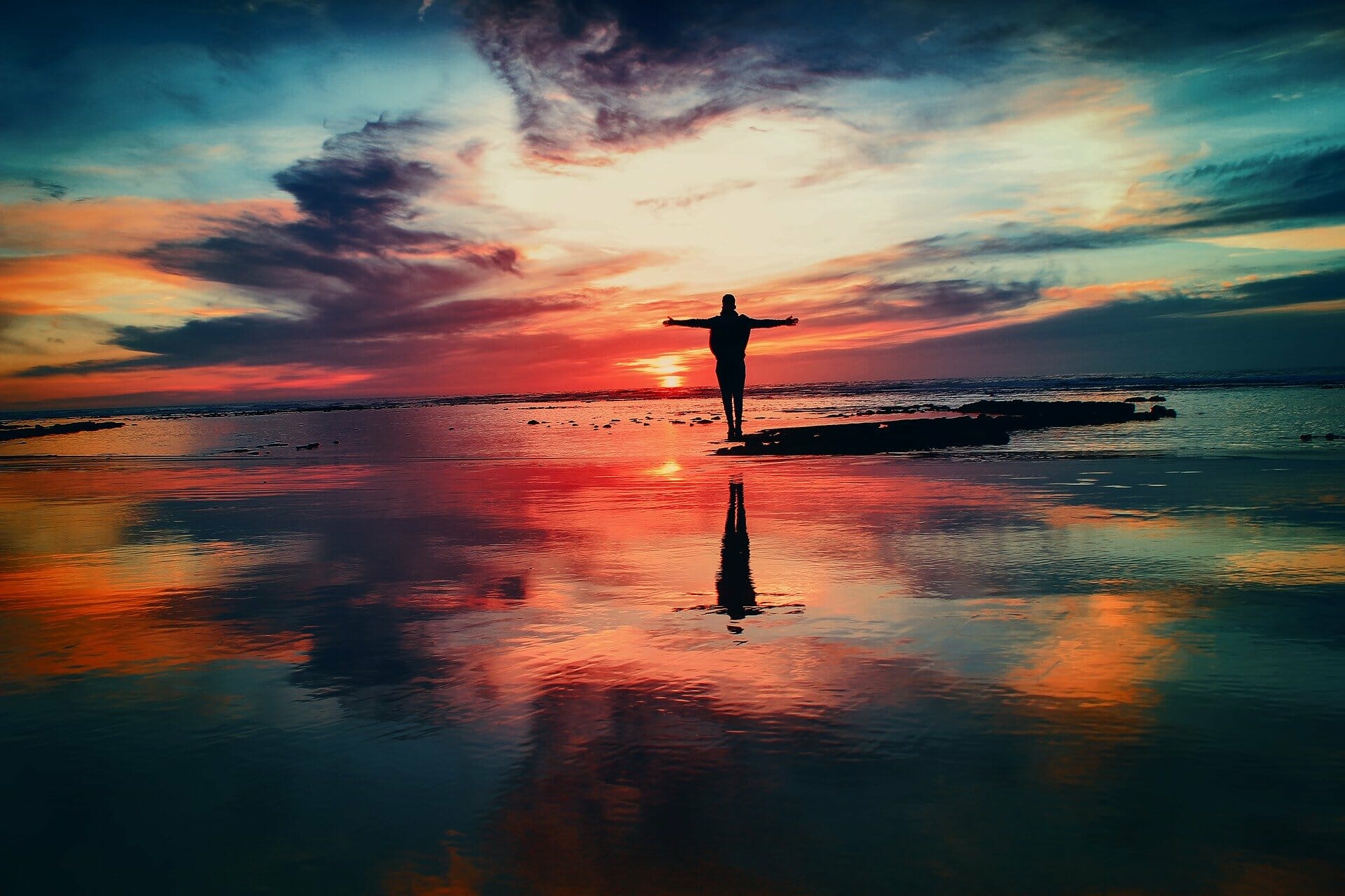 Silhouette of person in front of dramatic sky
